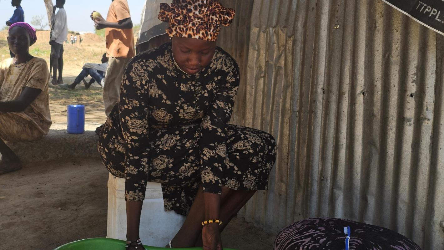 Photograph of young woman in displacement camp