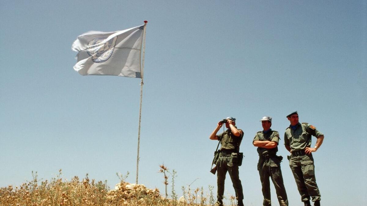 Peacekeepers watch out from a hill.