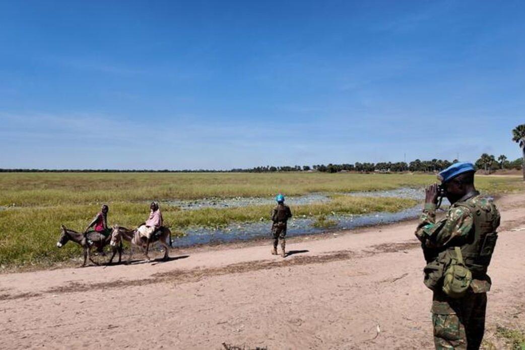 Villagers on the back of a donkey, peacekeepers on patrol.